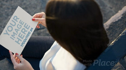 Woman Looking at a Flyer Video While Sitting Down Waiting