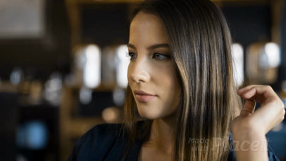 Woman Holding a Small Flyer While at a Cafe Video