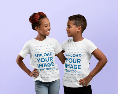 Mockup Featuring a Happy Girl and a Boy Wearing T-Shirts at a Studio