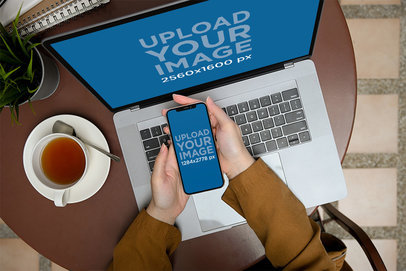 MacBook Pro Mockup Featuring a Man Checking His iPhone at a Coffee Shop m24416-r-el2