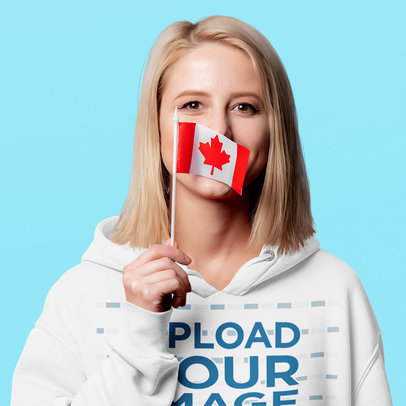 Hoodie Mockup Featuring a Woman Holding a Little Canadian Flag m25968-r-el2