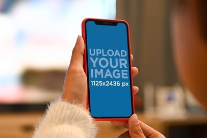 Over-the-Shoulder Mockup of a Woman Using Her iPhone 11 Pro 
