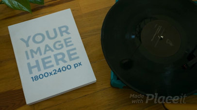 Video of a Book Lying Alongside a Turntable with a Vinyl on It Mockup