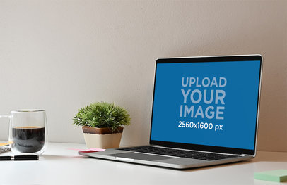 Mockup of a Neat Desk with a MacBook and a Coffee