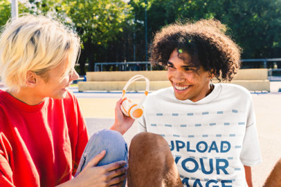 T-Shirt Mockup of a Man with Curly Hair and a Nose Ring Hanging out with a Friend