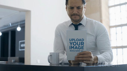 Business Man Having a Coffee While Taking a Look at a Book Video Mockup a14152