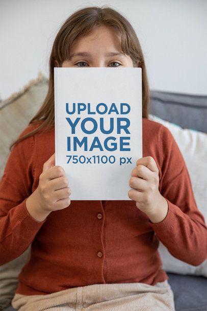 Mockup of a Girl Holding a Book and Looking at the Camera