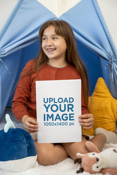 Mockup of a Girl Holding a Book While Sitting in Her Room
