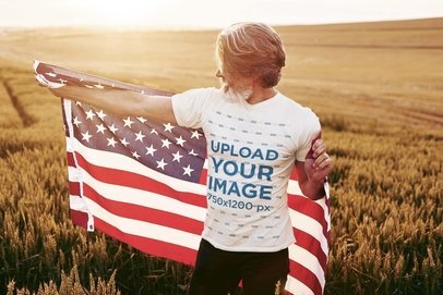 T-Shirt Mockup Featuring a Bearded Senior Man Posing With an American Flag