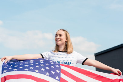 Ringer T-Shirt Mockup Featuring a Woman Holding an American Flag