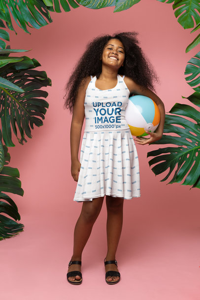 Skater Dress Mockup of a Girl Posing at a Tropical-Themed Setting While Holding a Beach Ball