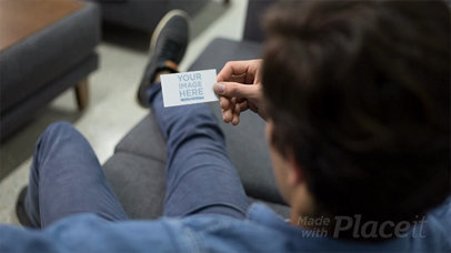 Guy Talking With His Phone Looking at a Business Card