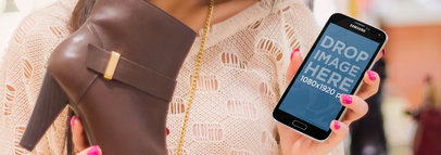 Samsung Galaxy in Portrait Position Mockup of a Woman Holding a Shoe