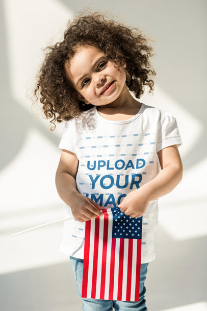 T-Shirt Mockup of a Little Girl Holding a Flag of the United States