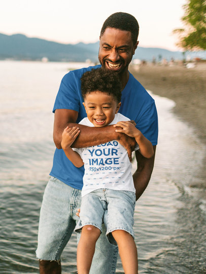 T-Shirt Mockup Featuring a Boy Having Fun With His Dad at a Lake