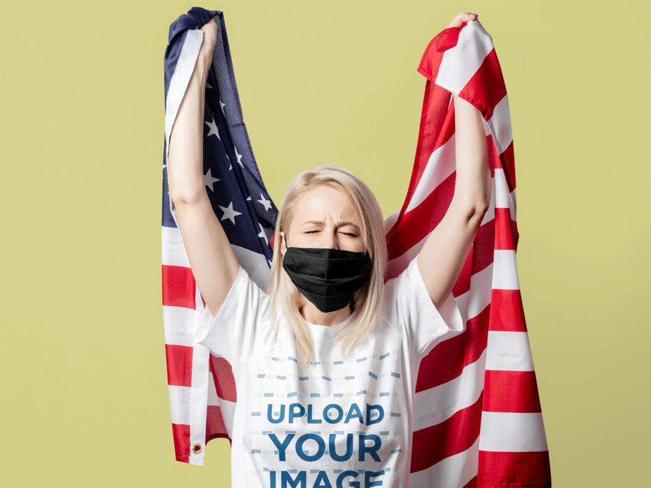 Patriotic Mockup of a Woman Wearing a Tee While Holding an American Flag