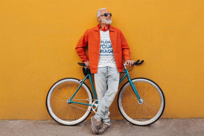 Round-Neck T-Shirt Mockup Featuring a Happy Senior Man Leaning Against a Bike