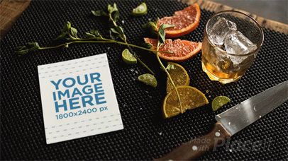 Flyer Lying on a Table With Knife and Lemon While Glass Ice is Moving in Stop Motion a13723