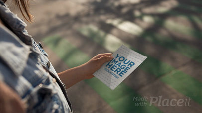 Woman Walking While Holding a Flyer in Stop Motion