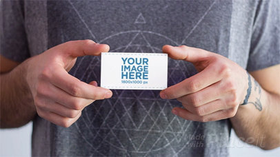 Stop Motion of a Guy Holding a Business Card That Magically Disappears a13784