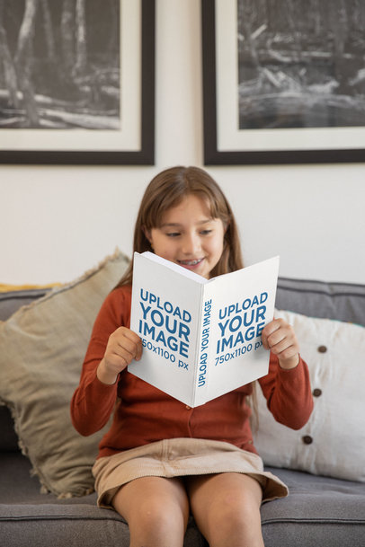 Mockup of a Girl Holding Hard Cover Book at Home