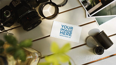 Stop Motion of a Business Card Lying on a Photographers White Table While Things Are Moving