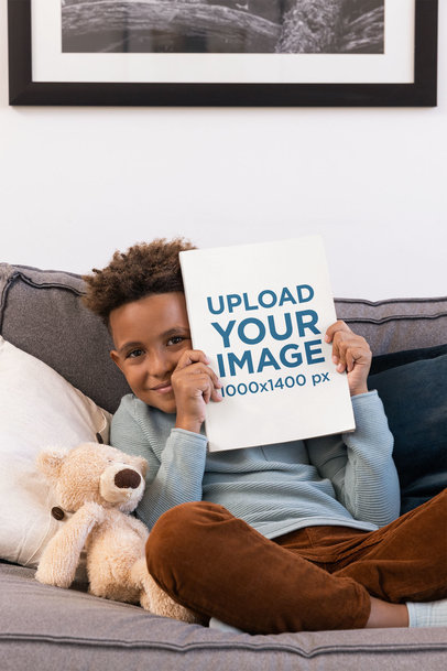 Mockup of a Little Boy Showcasing His Book