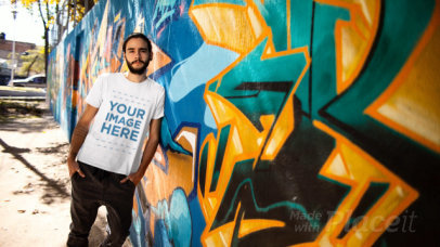 Hipster Guy with a Man Bun Leaning Against a Graffiti Wall Wearing a T-Shirt Stop Motion
