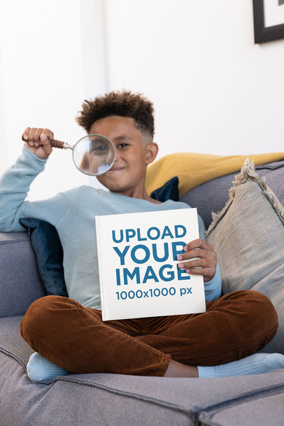 Mockup of a Boy Holding a Magnifying Glass and a Book