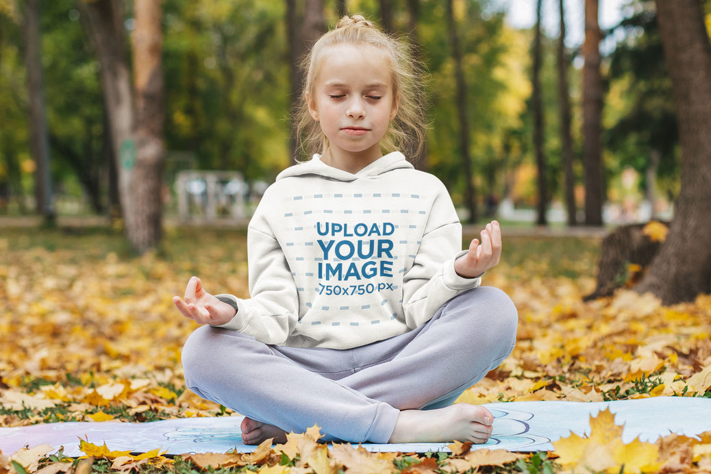 Hoodie Mockup of a Little Girl Meditating at a Park