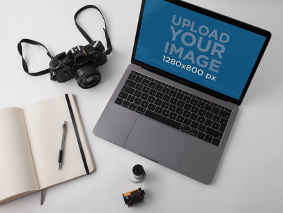 MacBook Pro Mockup Lying on a White Desk Near an Analog Camera a19516