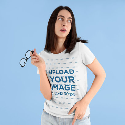 T-Shirt Mockup Featuring a Woman Holding a Pair of Glasses