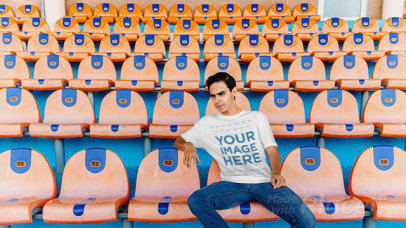 T-Shirt Video of a Young Man Sitting in the Stadium Bleachers Cheering a13227