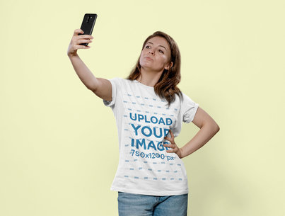 Round-Neck T-Shirt Mockup of a Woman Taking a Selfie in a Studio