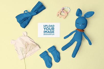 Mockup of a Greeting Card Placed Around Baby Toys and Clothes m26987