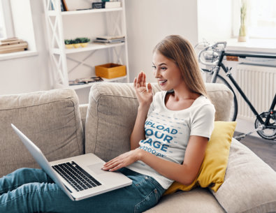 T-Shirt Mockup of a Young Woman Having a Videoconference at Home