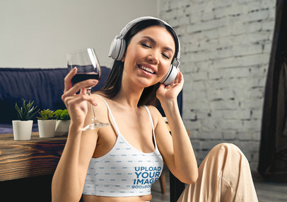 Crop Top Mockup of a Happy Woman Listening to Music With a Glass of Red Wine
