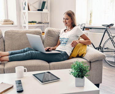 T-Shirt Mockup Featuring a Happy Young Woman Working From Home