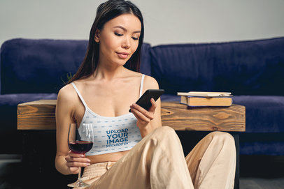 Sports Bra Mockup Featuring a Woman Drinking Wine at Home