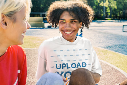 Oversized T-Shirt Mockup of a Young Man Talking to a Friend