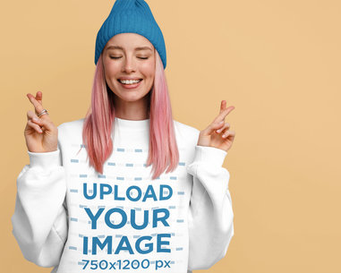 Sweatshirt Mockup of a Woman With Her Fingers Crossed in a Studio