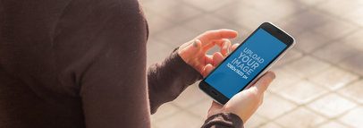 Samsung Galaxy in Portrait Position Mockup Featuring a Woman Wearing a Sweater