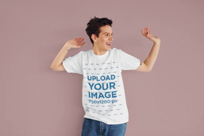 T-Shirt Mockup Featuring a Happy Young Man in a Studio