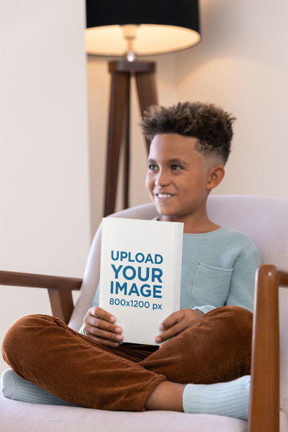 Mockup of a Kid Showcasing a Book at Home