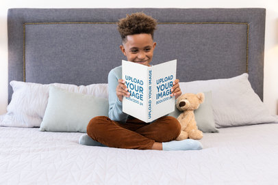 Book Mockup of a Little Boy Reading in His Bed 