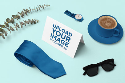 Mockup of a Greeting Card Placed on a Customizable Backgroud Surrounded by Some Accessories m26965