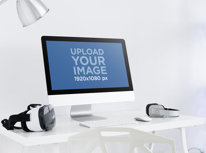 iMac Mockup Featuring a VR Headset and a Pair of Headphones Placed on a Desk m15952-r-el2