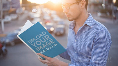 Hipster Guy Without Beard Reading a Book Stop Motion While the Sun Sets on the City