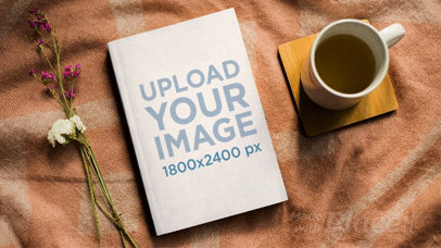 Book Lying on a Wool Cloth with a Teacup Filling And Emptying Itself in Stop Motion a13868