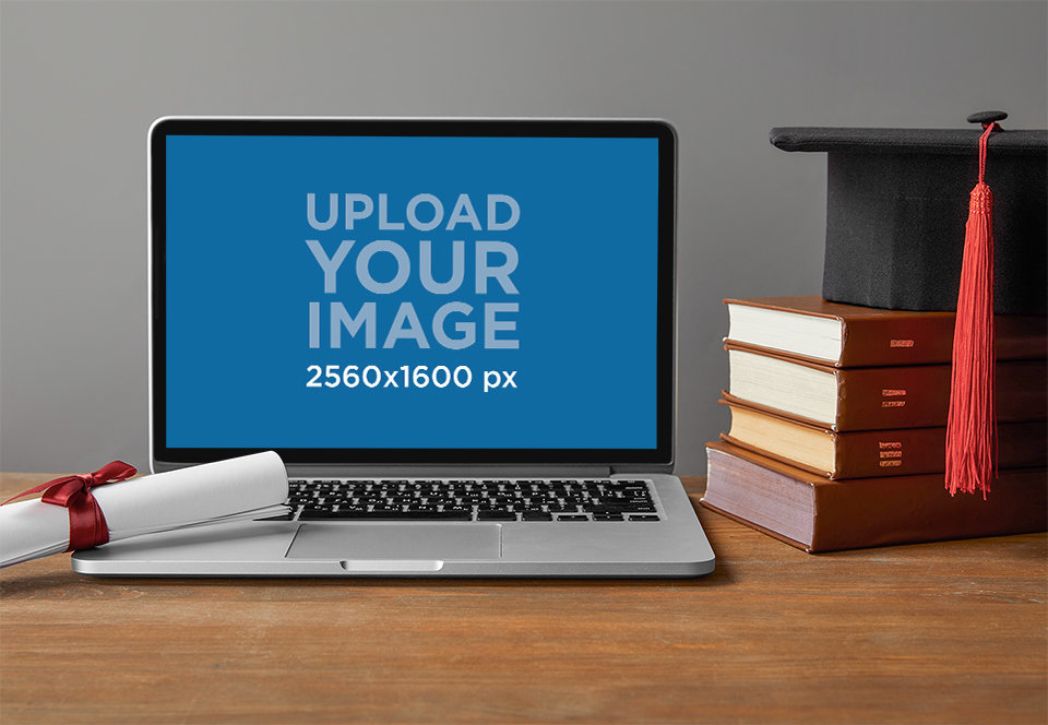 Mockup of a MacBook Featuring a Graduate Cap and a Diploma